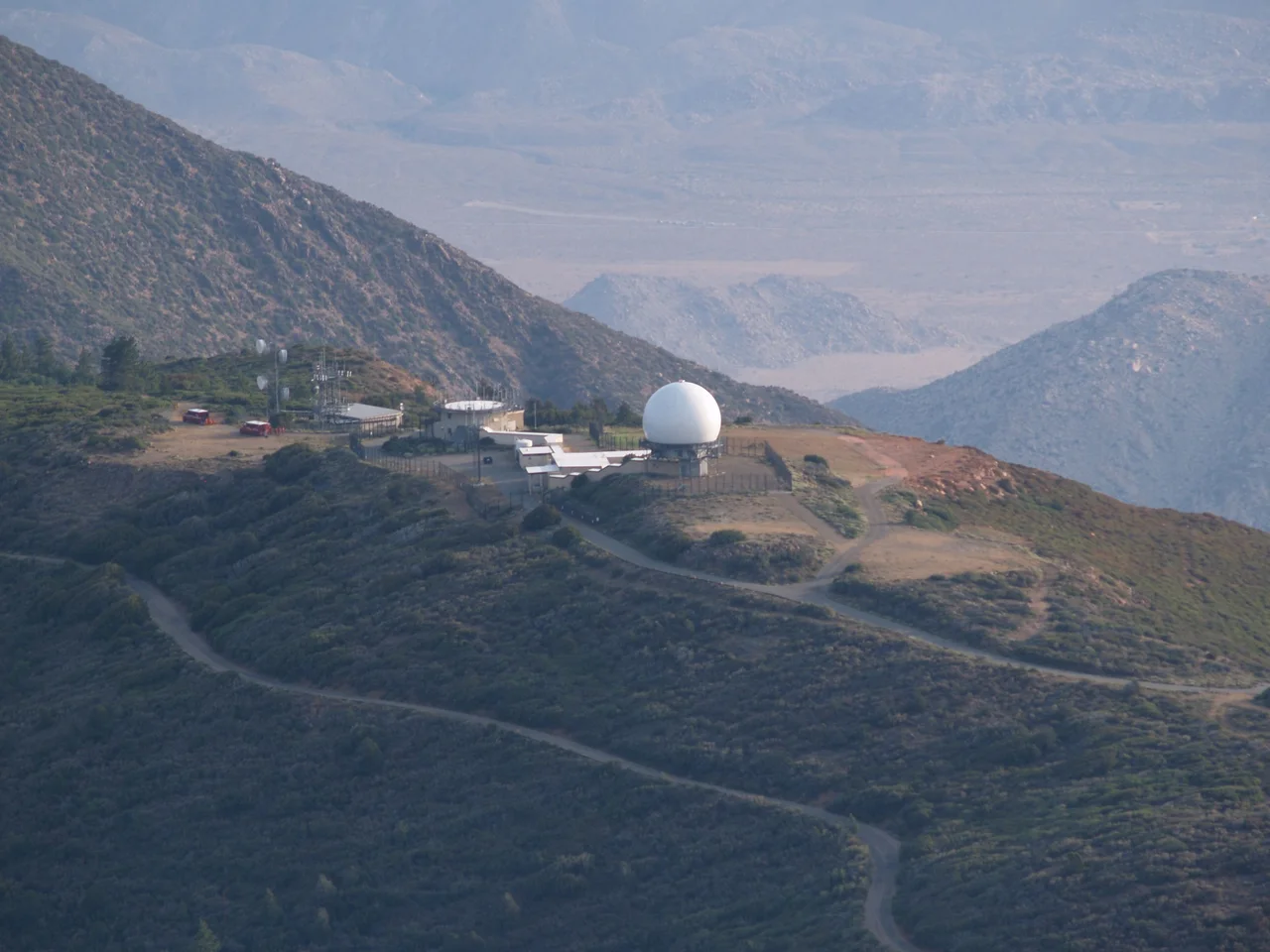 Photo of the Mt. Laguna FAA Station (formerly USAF Station) taken during the Chariot Fire. Two fire vehicles can be seen parked nearby to defend the area.