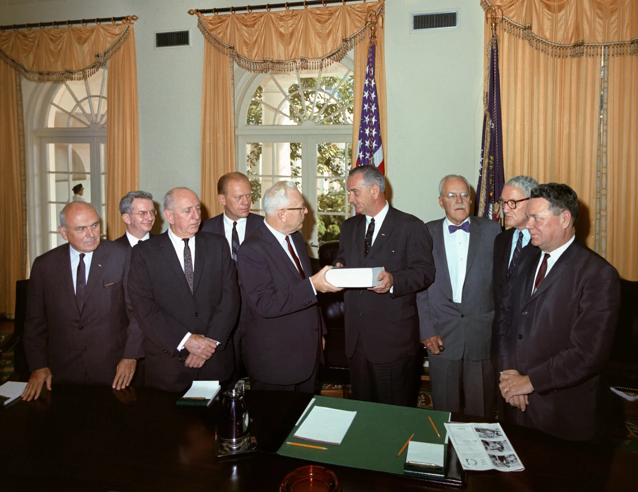 Members of the Warren Commission officially present their report on the assassination of President John F. Kennedy to President Lyndon Johnson. Cabinet Room, White House, Washington DC.
L-R: John McCloy, J. Lee Rankin (General Counsel), Senator Richard Russell, Congressman Gerald Ford, Chief Justice Earl Warren, President Lyndon B. Johnson, Allen Dulles, Senator John Sherman Cooper, and Congressman Hale Boggs