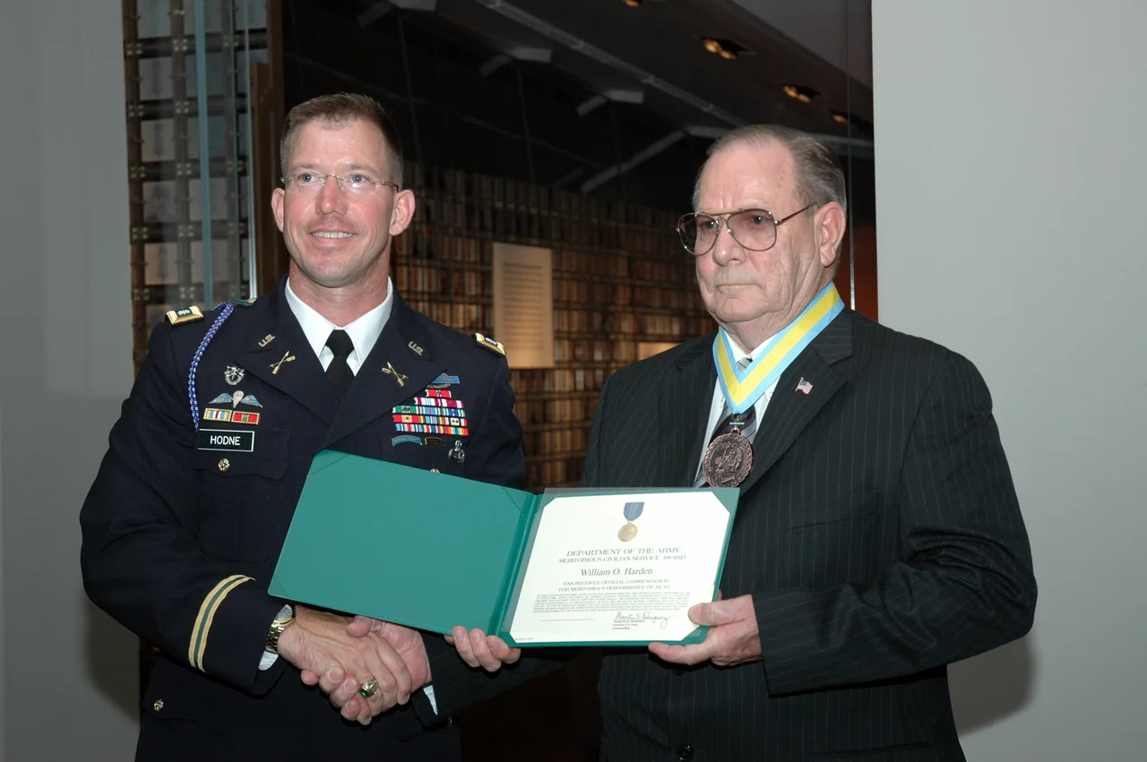 FORT BENNING, Ga.--Lt. Col. Daniel Hodne, commander, U.S. Army Marksmanship Unit, presents William O. Harden with the Meritorious Civilian Service Award Sept. 11 at the National Infantry Museum. Harden was honored by the Soldiers and civilians of the USAMU along with numerous guests for his 52 years of service to the country. 
(Photo by Ray Arredondo)