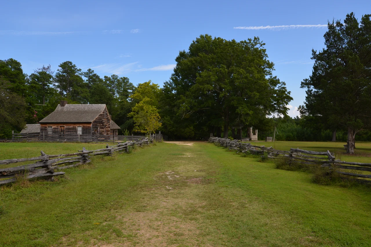 Bennett Place, a carefully reconstructed historic farm in Durham, North Carolina, the site of the largest surrender of Confederate soldiers during the American Civil War on April 26, 1865. Showing, from left to right, the kitchen, the farmhouse, and the memorial monument.