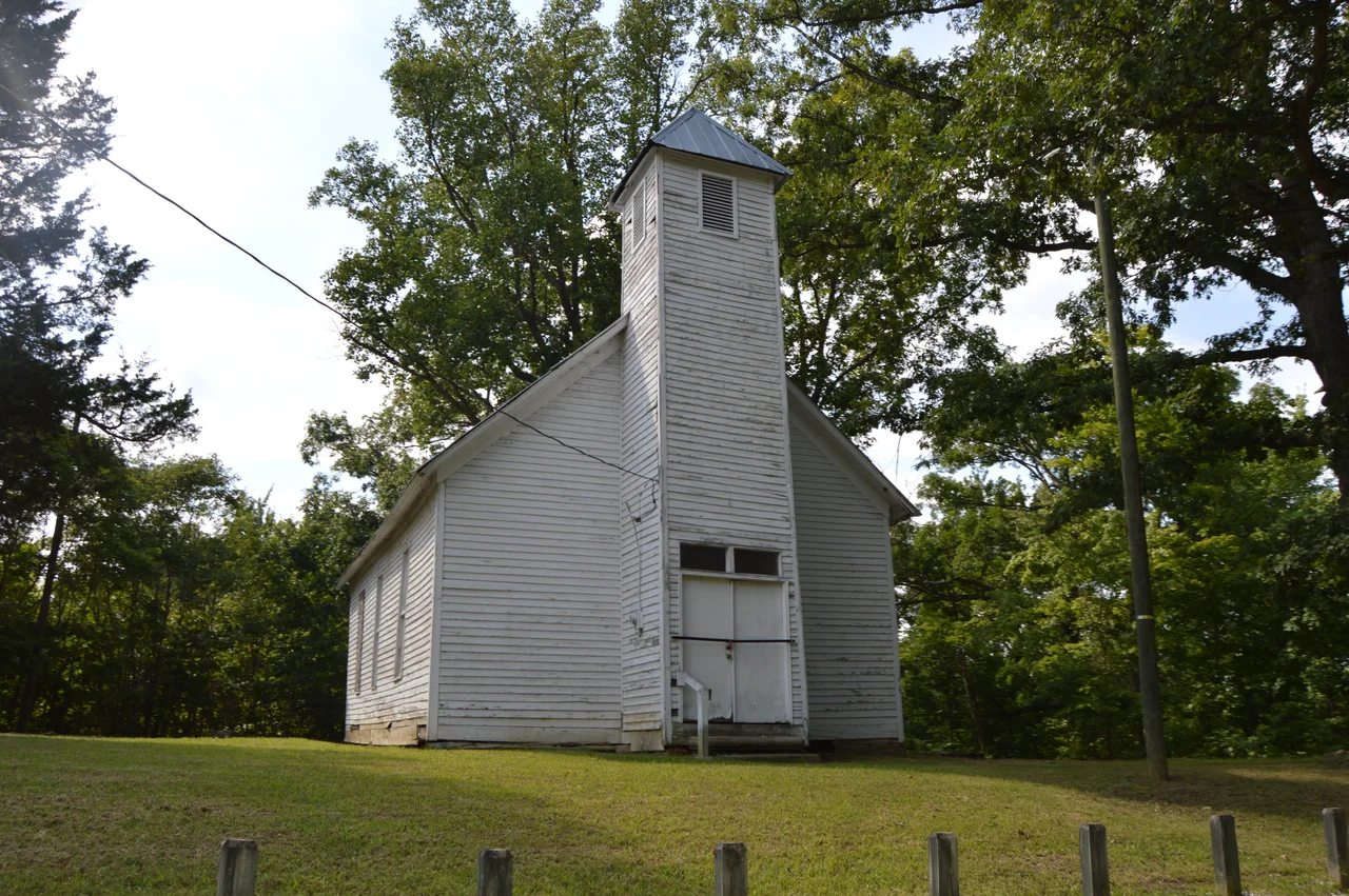 Front and southern side of the former Macedonia Church, located at the junction of Roads 120 and 144 north of Burlington in Fayette Township, Lawrence County, Ohio, United States.  Built in 1849, it is listed on the National Register of Historic Places.