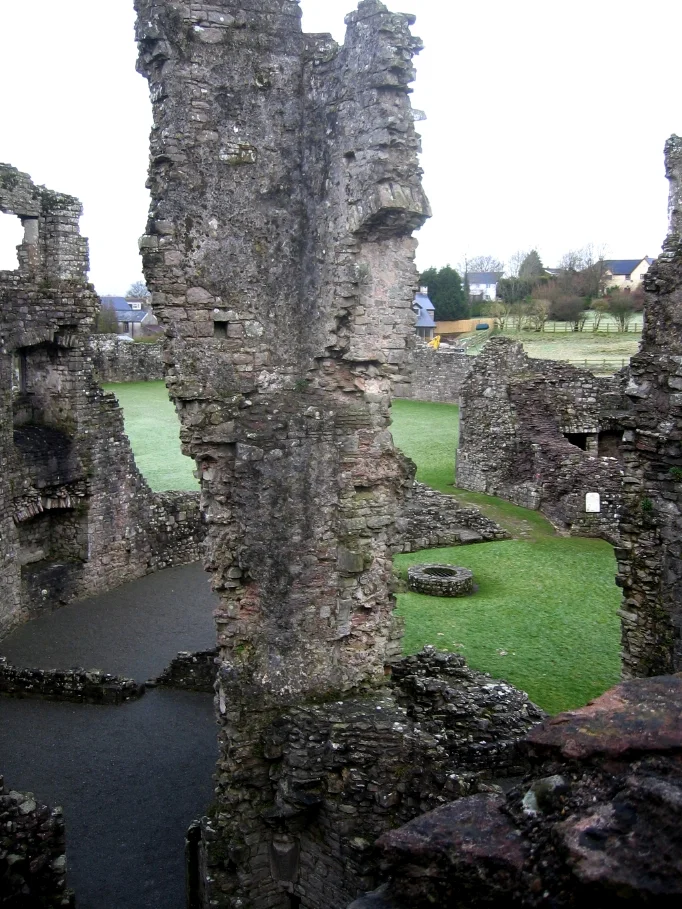 Coity Castle, Wales, view of the ground floor service rooms, probably including a kitchen, with ovens and the base of a large malting kiln remaining. Photo is taken from the third floor stairway of the living quarters, extensively remodelled in the 16th Century