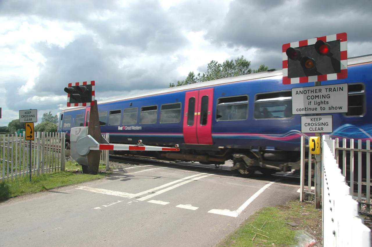 Railway level crossing, Ufton Nervet, West Berkshire: First Great Western Class 165 train heading for Newbury. On 6 November 2004, a chef named Bryan Drysdale committed suicide by parking his car on this level crossing, which only has half barriers, rather than full barriers used on many other level crossings. An InterCity 125 operated by First Great Western running from London Paddington to Plymouth collided with the car. 7 people, including Drysdale, were killed and 71 were injured. There was another suicide at this level crossing, in 2009, when a man jumped in front of a train, and also 4 subsequent incidents on the level crossing, including a near miss. These incidents have led to considerable debate about the safety of half-barrier level crossings on the UK rail network.