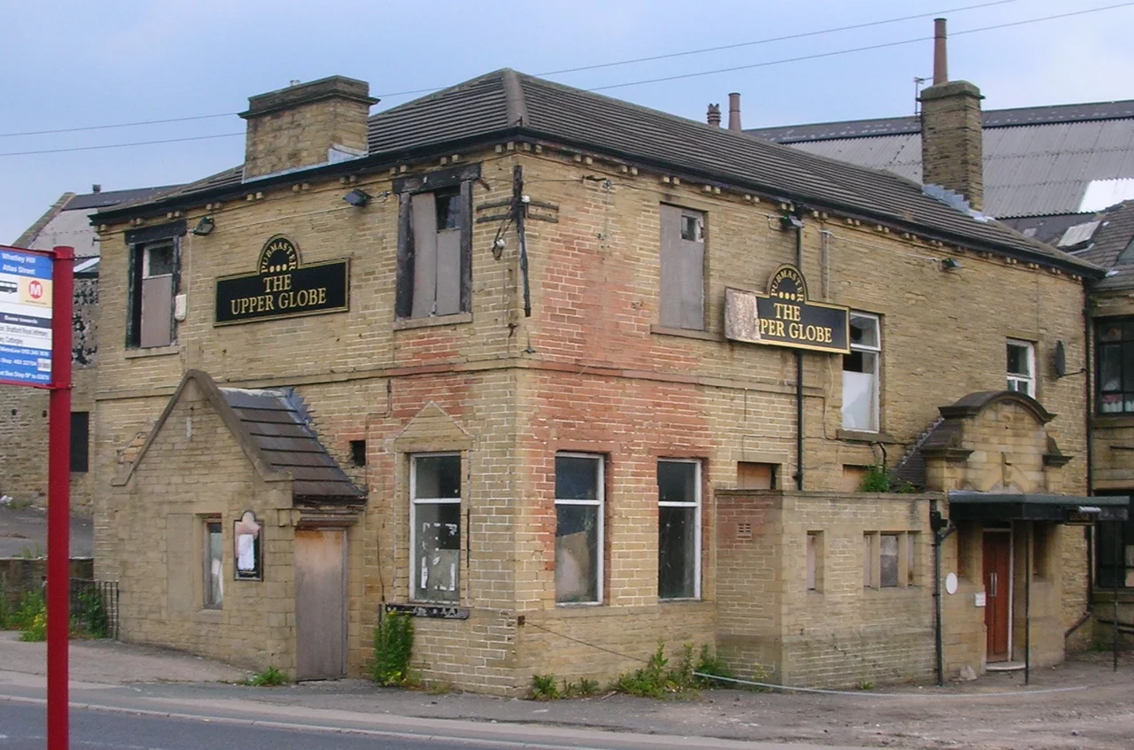 A picture of the Upper Globe pub on Toller Lane in Bradford. It was attacked during the Bradford Riots in 2001, and has since laid disused.
MGSpiller 13:12, 25 June 2006 (UTC)
This is untrue, it was damaged in the Manningham riots which were held over two days in 1995. There was a band playing there that evening who still carried on playing to scared patrons, themselves in fear but they did their best to carry on. This pub has stood empty since then. They kept patrons locked inside for their safety despite the windows being smashed, but it was less safe for them to leave.
