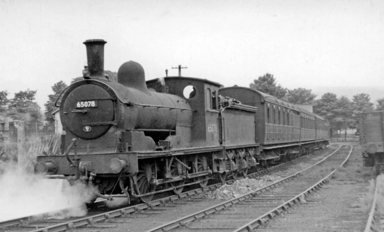Last Train waiting to leave Wearhead for Bishop Auckland.
View NW, towards buffer-stops; ex-NE terminus of line from Bishop Auckland, 27/6/53: the locomotive is ex-NE J21 No. 65078. Goods traffic continued up the valley as far as St John's Chapel until 2/1/61; a passenger service, Bishop Auckland - Stanhope was restored by the Weardale Railway from 23/5/10. See also 2047797 and NZ2029 : The Last Train to Wearhead waits to leave Bishop Auckland Station.