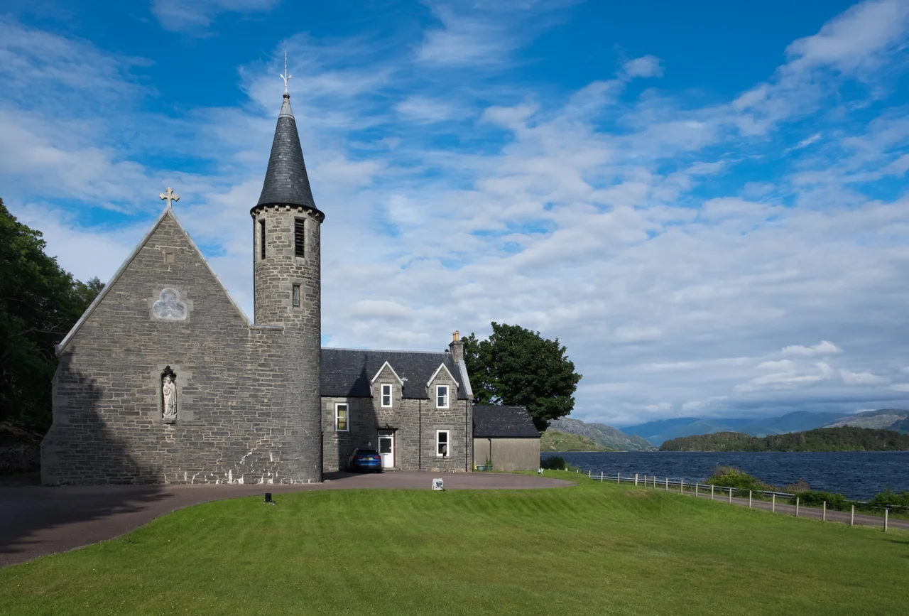 The Roman Catholic church of Our Lady of Perpetual Succour &amp; St Cumin in Morar, Scotland. This church lies on the banks of Loch Morar, which with a maximum depth of 310 m, is the deepest body of freshwater in the British Isles.