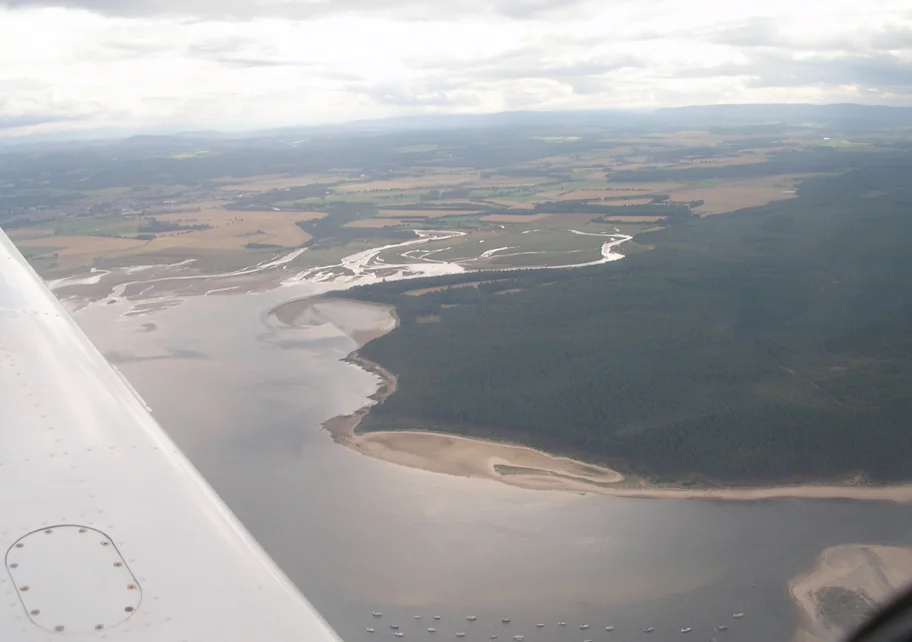 Aerial photo of Findhorn Bay, with the east end of the Culbin Forest at right and the estuary of the en:River Findhorn at centre.