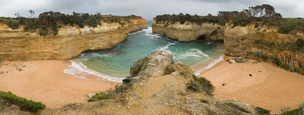 A panorama of 4 segments taken from the cliffs looking down towards Loch Ard Gorge and the beach. Taken with a Canon 10D and 17-40mm f/4L lens in July 2005.