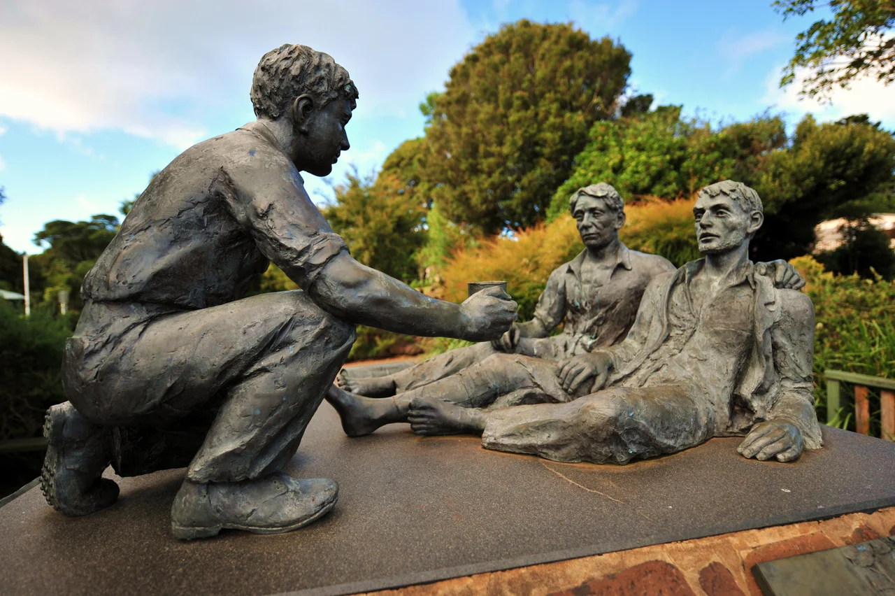 A bronze statue at O'Reilly's Rainforest Retreat, Queensland, Australia. Bernard O'Reilly in bronze depicting his rescue of the two plane crash victims in 1932.