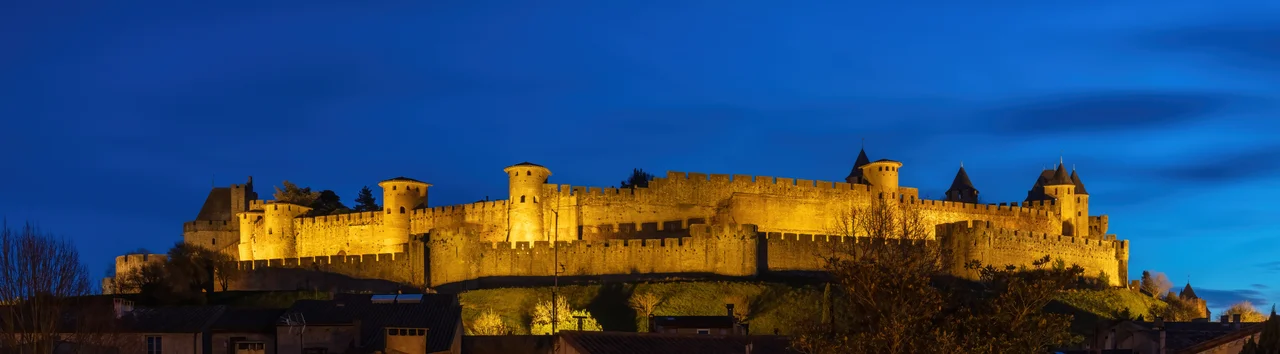 Fortified city of Carcassonne during the blue hour, France. Founded during the Gallo-Roman period, the citadel derives its reputation from its 3 kilometres (1.9 mi) long double surrounding walls interspersed by 52 towers. The medieval citadel, situated on a hill on the right bank of the river Aude, was restored at the end of the 19th century by the theorist and architect Eugène Viollet-le-Duc. In 1997, it was added to the UNESCO list of World Heritage Sites because of its exceptional testimony to the architecture and planning of a medieval fortress town.