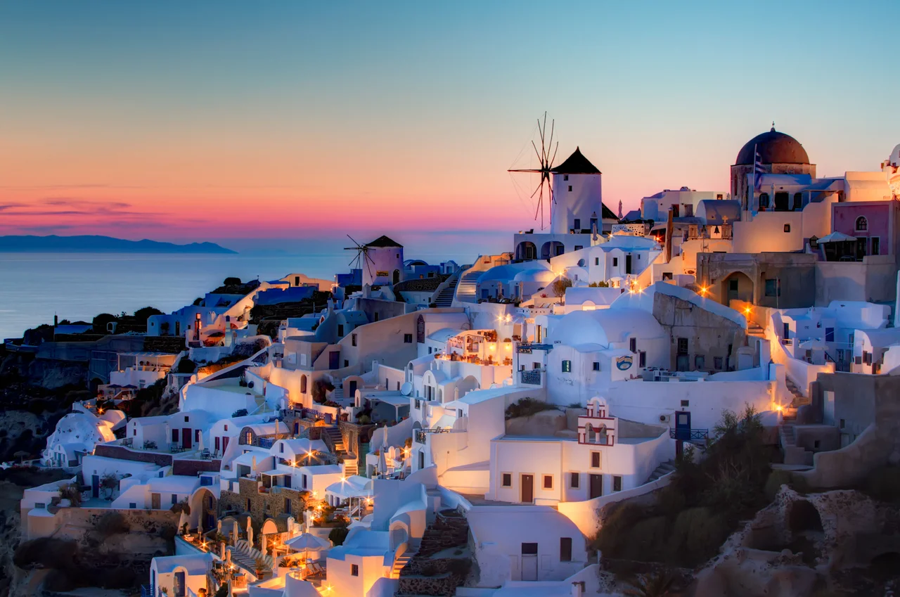 Sunset in Oia, Santorini.
Here is my version of the sunset shot in Oia. This is a blend of 3 shots, 1.3 to 20 seconds, processed as follows:
1) Reduce noice on all 3 raws.
2) Create HRD in Photomatix
3) Blend using Exposure Fusion, sliders set to produce the most natural looking image while still showing some detail in the very dark areas.
4) PS smart sharpen.
5) PS burn the bottom
6) Nik Brilliance and warming
7) Nik Indian summer to warm th elights, masked to not affect the rest.
8) Nik sunlight, brushed over the buildings to add more light
9) Nik Glamour Glow to remove detail in the dark areas.
10) Detailed curves lightening pn windmills.

11) Dodge buildings that were too dark.