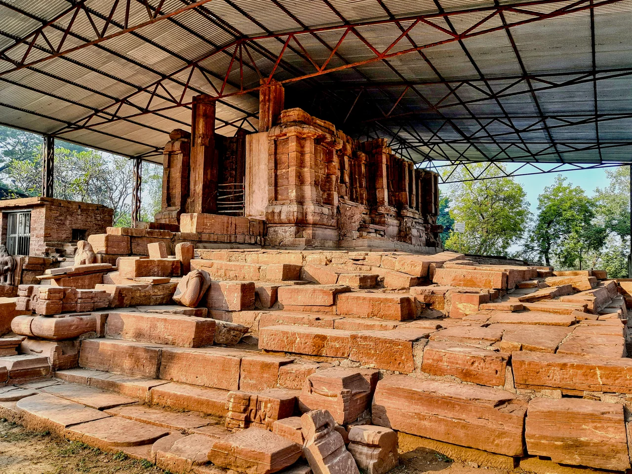 The Tala site in Chhattisgarh is a collection of major Hindu temples and ruins from the early 6th century (c. 525 CE), making it one of the oldest known Hindu monuments in Chhattisgarh that have survived into the modern age. Before 1950, colonial era British and Indian archaeologists knew of scattered ruins and a large mound at Tala. The site was finally excavated and studied in the late 1970s through 1980s, thus unearthing the scale and significance of the Tala site.
The Devrani Jethani temples site is located on the eastern banks of the Maniyari river, near a Hindu pilgrimage site and collection of modern era temples. The historic site consist of two temples made from sandstone. The larger Jethani temple is mostly in ruins. The smaller Devrani temple is more intact but also ruined. They are next to each other, and their modern era names mean "elder daughter-in-law" and "younger daughter-in-law" in many Indian languages, signifying that they are housed together, related and yet one is bit older and bigger. Both temples are under a shed (added in the 2010s) to prevent erosion from rain. A small museum at the site holds some of the better preserved 6th-century sculpture of Shaivism, Vaishnavism, Shaktism traditions, as well as Vedic deities.
The Jethani temple is quite large, spreads over 10000 square feet, with a platform and four stepped entrances. Huge damaged and fallen pillars, life size to larger than life size statues, naturally eroded structures, and some deliberately damaged Hindu artwork is visible. Of these, the bharavahakas (sculpted weight bearers below structural elements) are impressive as they facial expressions humorously show the dwarfs feeling the pressure of massive structure above them.
The better preserved Devrani temple is the oldest standing Hindu temple that can reliably dated to be from the ancient Kosala region mentioned in Indian epics. The dating is based on short inscriptions found here in a script style that existed prior to the 7th century. Further, the artwork here are of the quality found in some Gupta era sites in Madhya Pradesh and Vakataka era sites in eastern Maharashtra – both known to have flourished between the 3rd and 6th centuries. Thus, the Tala site has contributed a better understanding of art, Hindu iconography and creative innovation by about 550 CE in central and Deccan region of ancient India.
Tala enigmatic statue – a masterpiece of innovative creativity was unearthed in 1988. It is a stone statue about 5 tons in weight and larger than life (8 feet high), from a single rock, very likely produced at site with the temple. The exceptional aspect of the statue is that most of the man's visible body parts are other living beings. Snakes form his hair and a turban, a lizard forms his nose, lizard's hind legs form the brows, a frog his eyes, two fishes form his moustache, a crab shapes his chin and lip, two peacocks help form his ears, busts of two crocodiles shape his shoulder, a turtle his penis (in urdhvareta form, or ithyphallic), two lion cubs form his two knees, and so on. From fingers to toes, from a carefully interrelated fusion of living beings emerges the shape of a well built man. Further, many faces are carved on his chest and stomach. Since its discovery in 1988, scholars have offered many interpretations as to what this statue represents and signifies, particularly in light of the fact that it too is dated to early 6th century. Some suggest it to be a form of Shaiva and Vaishnava Hindu traditions, particularly Sadashiva, Matsya, Kurma, Narasimha and others avatars. An alternate theory is that the creature forms selected may be the vahanas of Hindu gods and goddesses, the artist thus implies and fuses the many gods and goddesses carried into one within the human form. There is no consensus yet. This Tala enigmatic statue stands in front of the Devrani temple and to the left of the steps that lead to its platform. This is where it was found.

The temple ruins, various artwork including the enigmatic statue attract reverential offerings and treated as a place for worship from the regional Hindus. It is also a tourist attraction, well connected with modern highways. The site is a declared national monument, under the protection and management of the ASI.