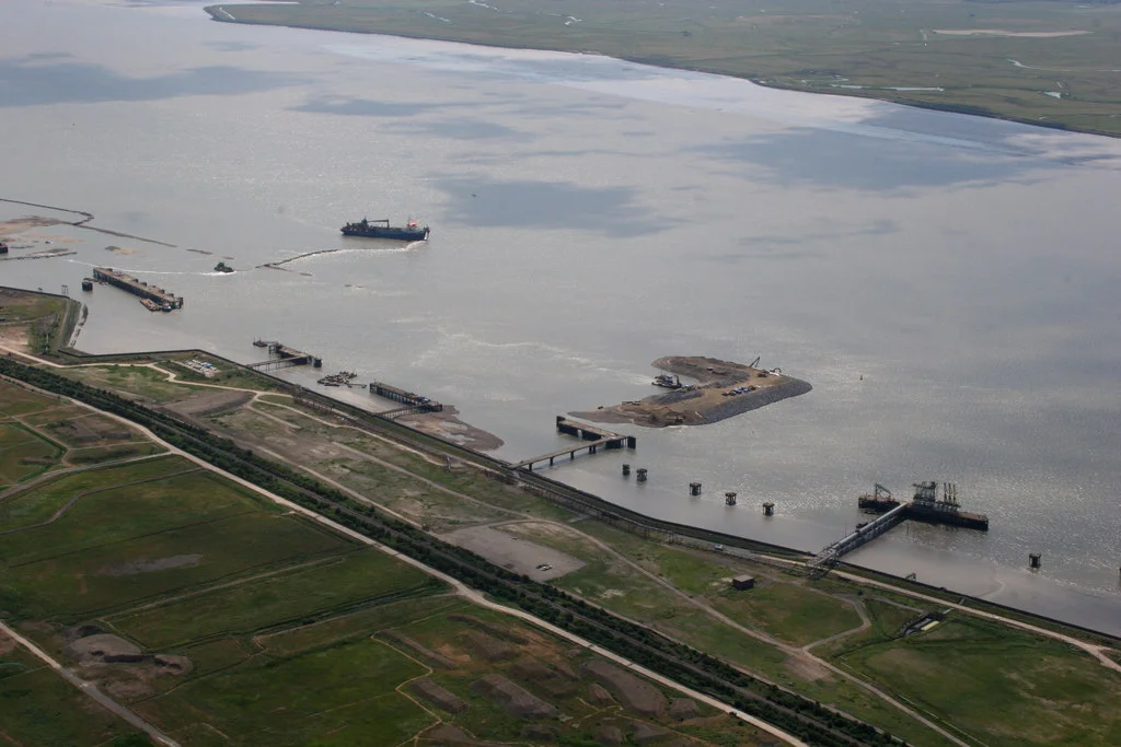 London Gateway Port, Thurrock, Great Britain.
This photo shows part of the construction of the new 'London Gateway' port at Shell Haven.
The existing jetties were from the now demolished Shell Haven Refinery.

Sand is being pumped from the bottom of the Thames to create the new waterfront.