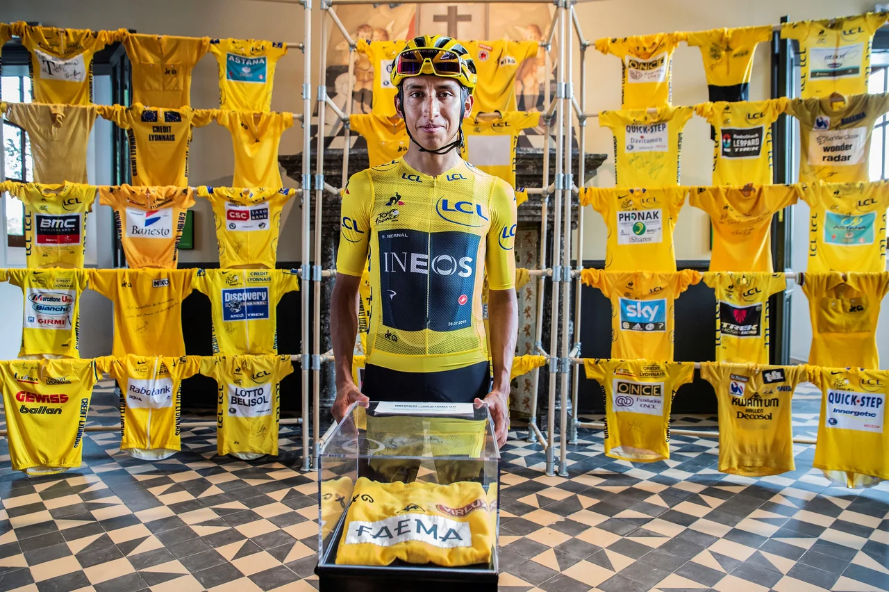 Egan Bernal, winner of the Tour de France 2019, poses with his yellow jersey in KOERS. Museum of Cycle Racing in Roeselare, Belgium, with the yellow jersey of Eddy Merckx and others yellow yerseys in the exhibition.