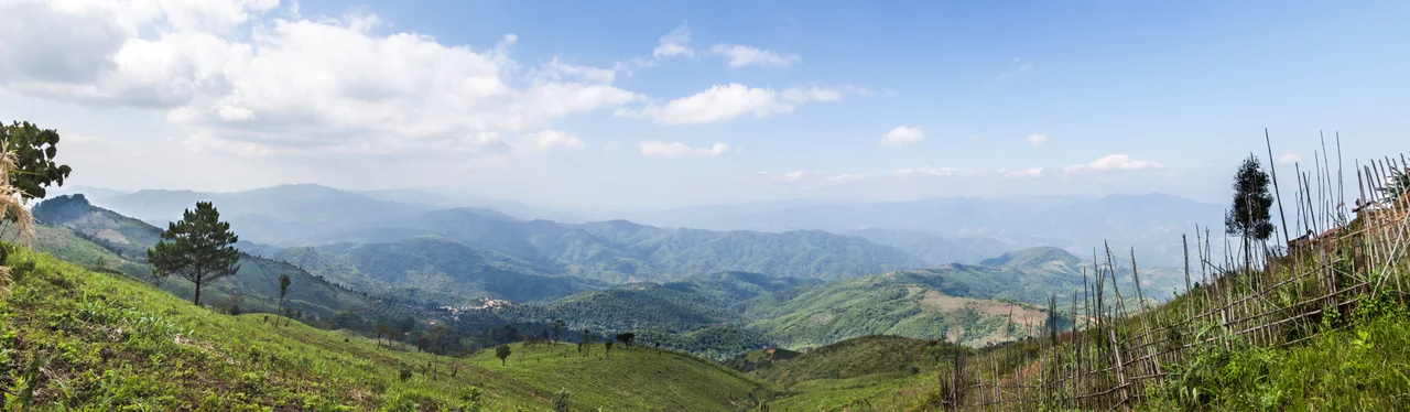 Looking out over Tachileik District, Shan State, Burma, into the heart of the Daen Lao Range from Thai road number 1149 in Mae Sai District, which runs partway along the border with Burma. Technically, I was standing inside Burma, if only by about 1 meter, when I made the images used in this panorama.
This image was created with Hugin.